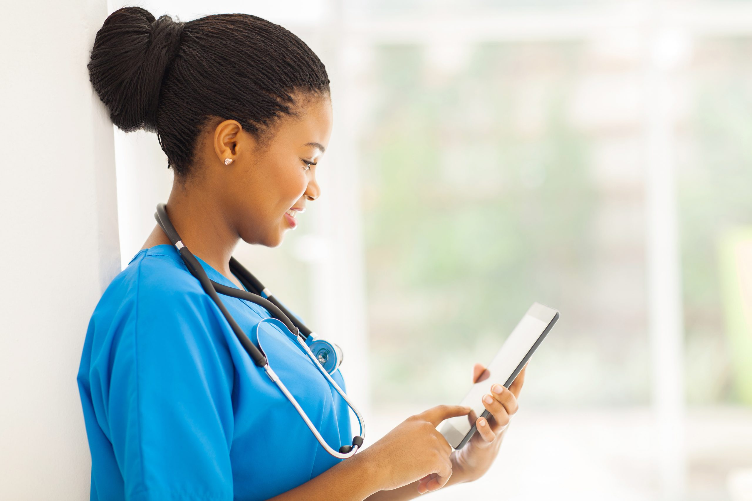 young happy african american medical worker using tablet computer